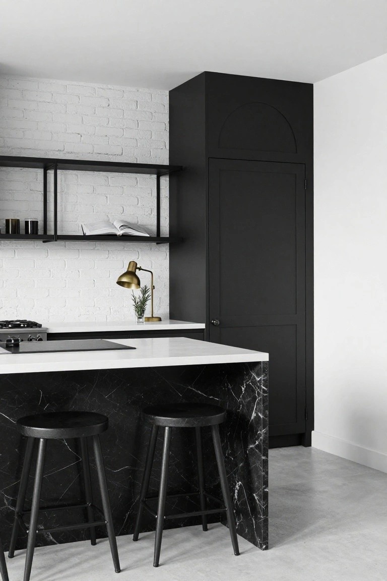 Modern kitchen with black bookmatched marble island, black stools, black cabinets, white brick backsplash, white counters, gold lamp, and shelving.