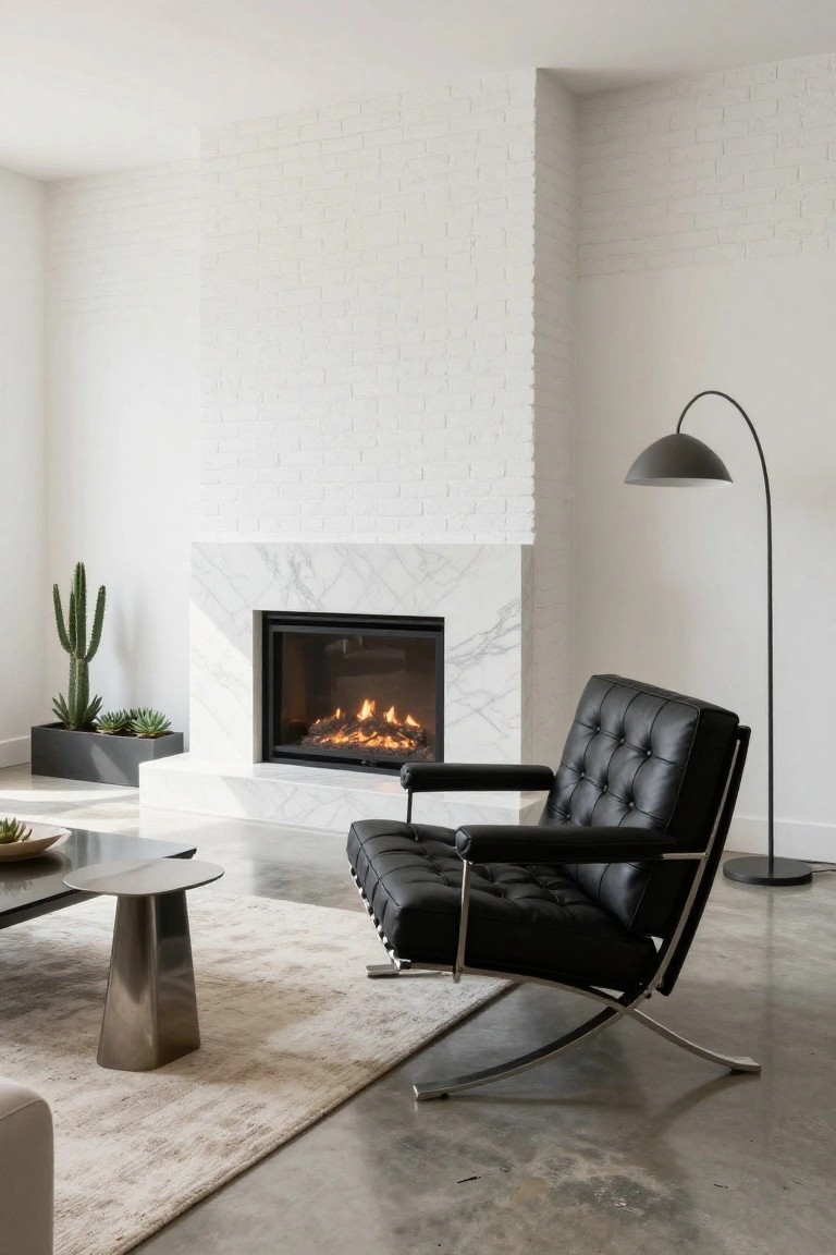 Modern living room with black tufted leather armchair near white marble gas fireplace, potted cactus plants, arc floor lamp, metal coffee table, and beige rug on polished concrete floor.