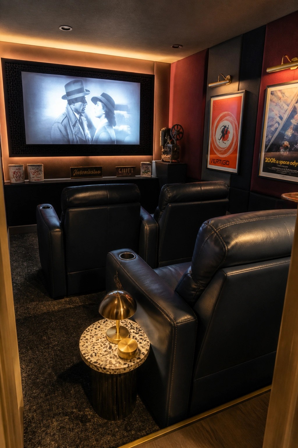 Black leather recliners in dark home theater with movie screen and Vertigo poster.