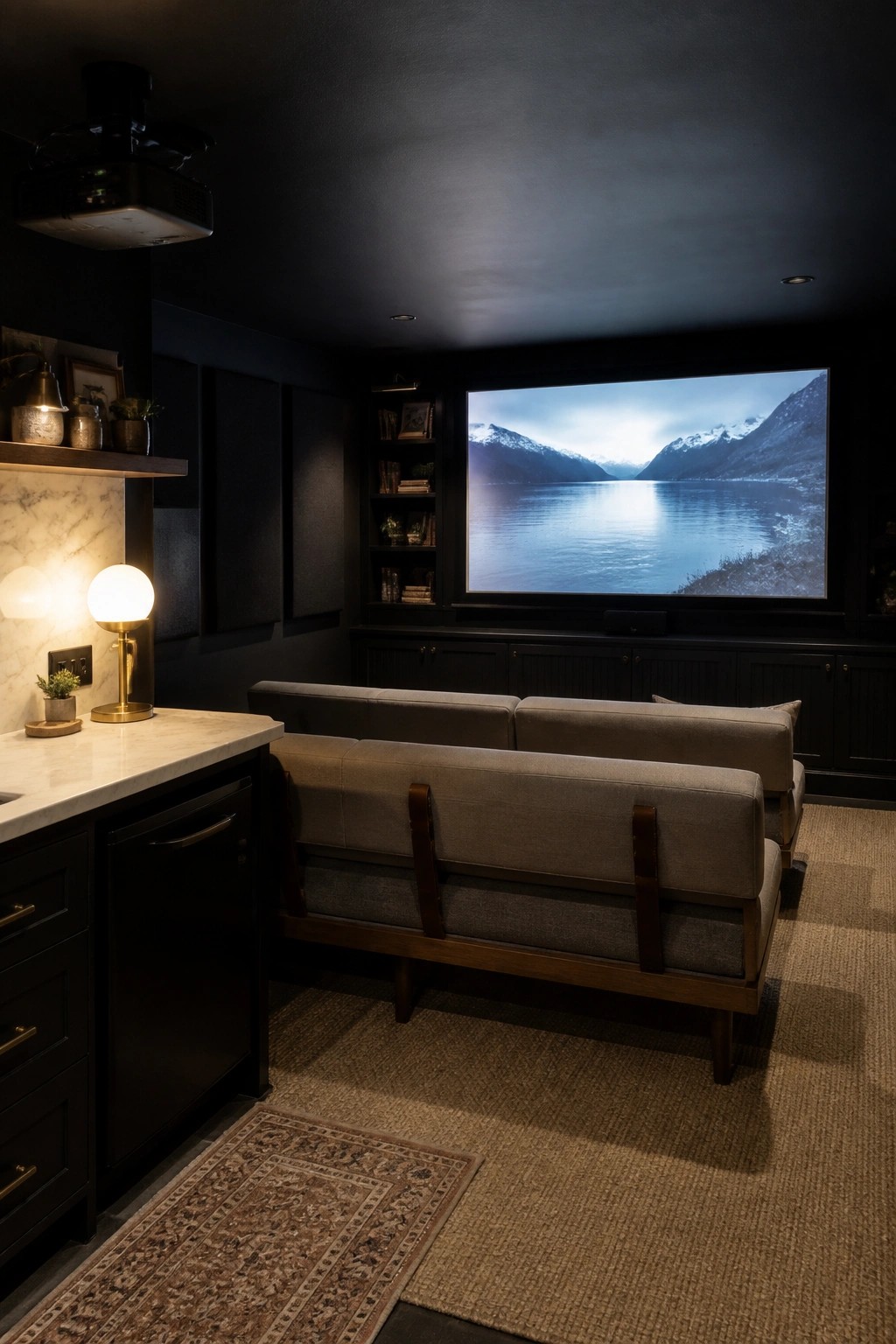 Dark home theater with gray sofas facing large mountain lake projection screen