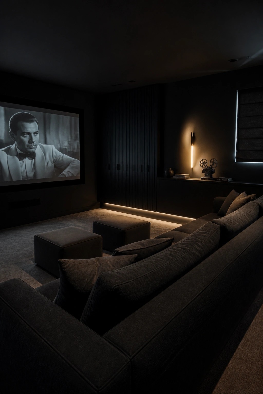 Dark home theater with sectional sofa, movie screen showing man in tuxedo, vintage projector.